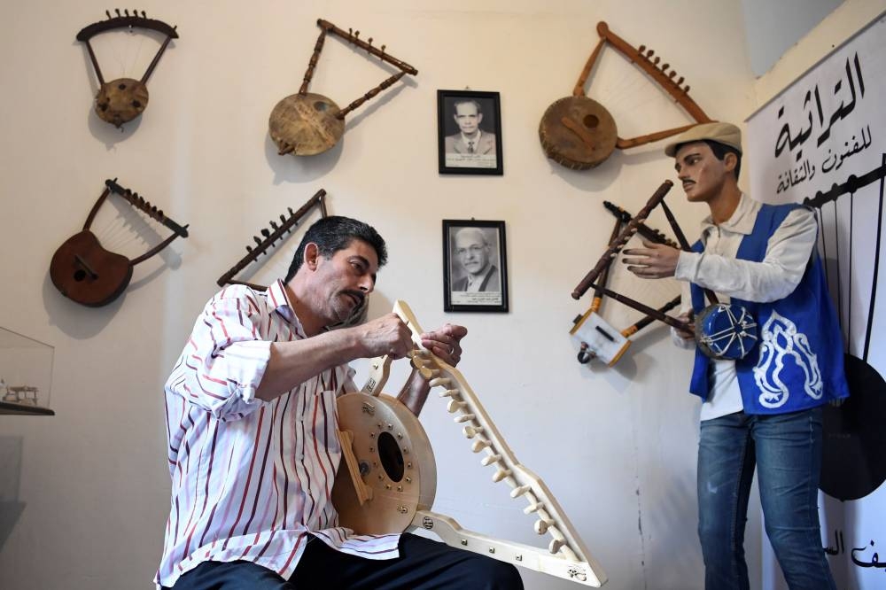 Egyptian craftsman Mohamed Ghaly adds the finishing touches on a semsemia fan that he made at the Canal 20 cultural museum in the northeastern city of Port Said at the northern terminus of the Suez Canal. The semsemia, a triangular lyre-lookalike instrument with a circle at the bottom and made of beech wood with steel strings, is believed to have ancient Egyptian roots, appearing on ornate engravings on tombs. — AFP