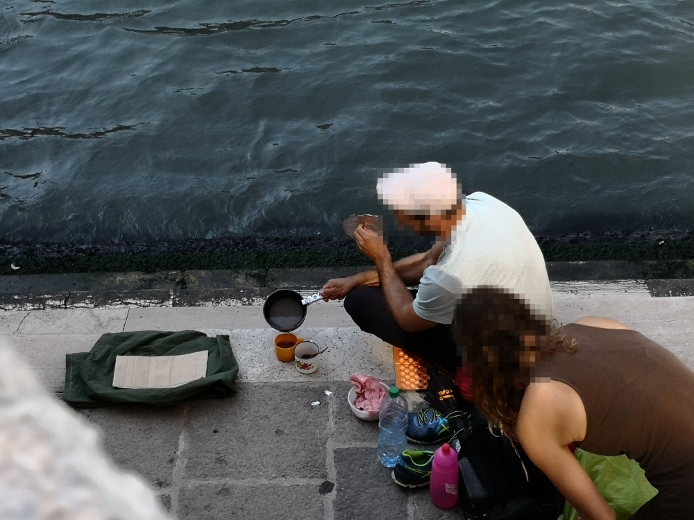 A handout picture released on Friday by the city of Venice shows a couple preparing coffee in front of the Rialto Bridge (Ponte de Rialto) the oldest of the four bridges spanning the Grand Canal in Venice, Italy. Two German tourists were fined and asked to leave the city after they were caught preparing coffee in front of the Rialto Bridge. — AFP