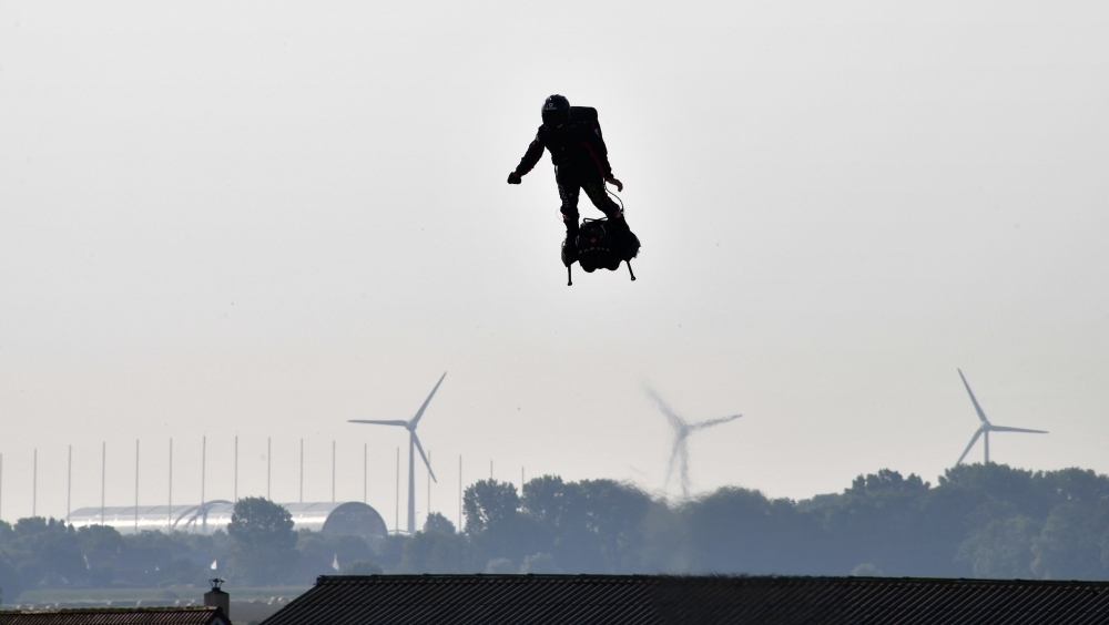 Franky Zapata, center, stands on his jet-powered 