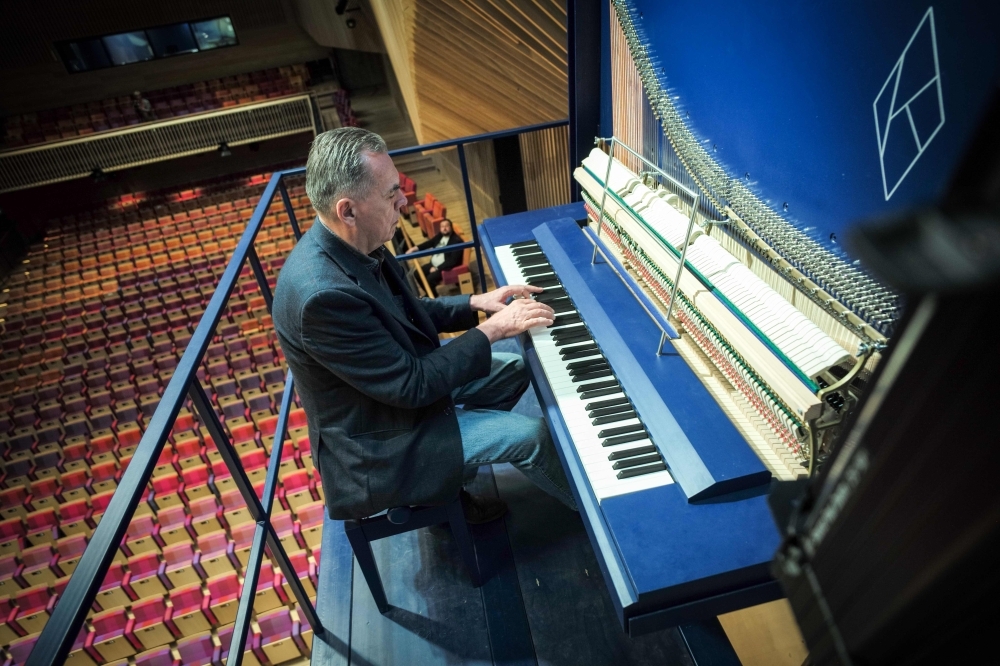 Piano constructor and builder David Klavins plays his new creation, the M470i vertical concert grand piano, with a height of 4,70 meters, at the new 