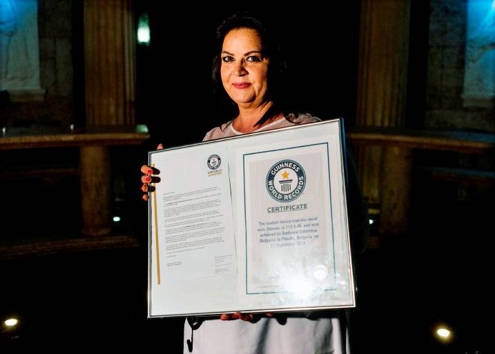 Bulgarian singer Smilyana Zaharieva shows her Guinness certificate during an interview with AFP in a dome-shaped hall in the village of Starosel, on July 8, 2019. — AFP