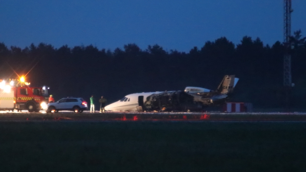 Emergency services are seen next to a Cessna 560XL that caught fire upon landing at Aarhus Airport in Tirstrup, Denmark, in the early hours of Tuesday. — FP