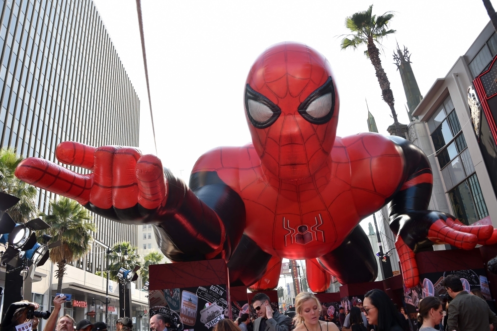 A giant inflatable Spider-Man is displayed on the red carpet for the 