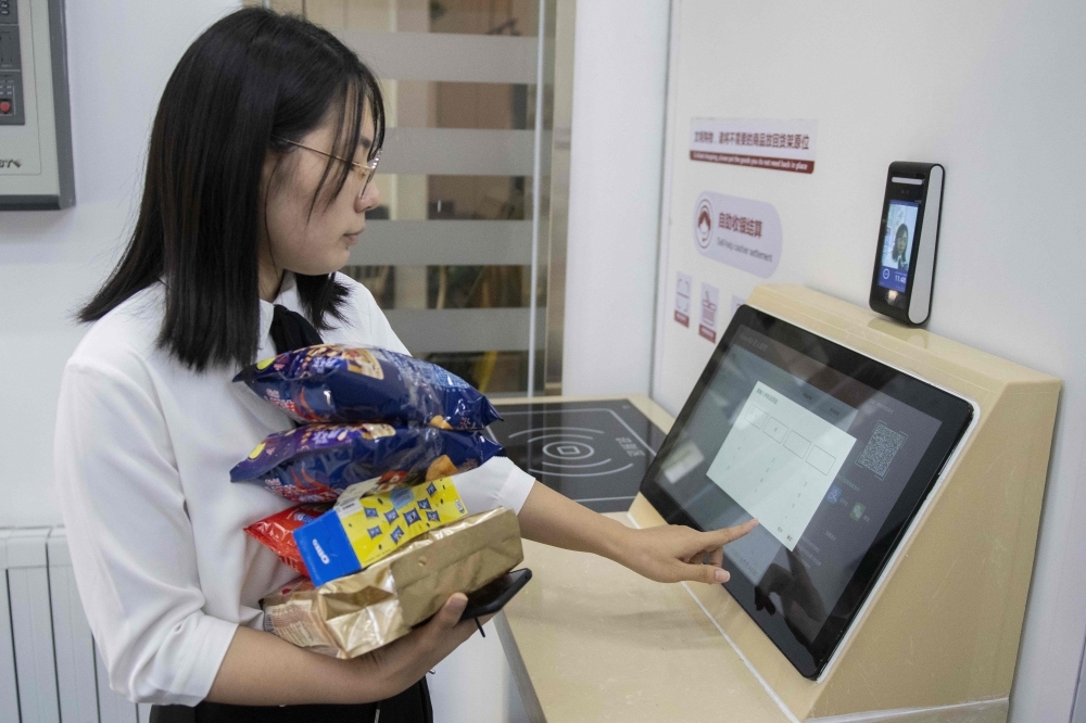 In this picture, a woman buys groceries at an IFuree Go self-service supermarket in Tianjin. China's mobile payment infrastructure is already among the most advanced in the world, but facial payment technology is bidding to make QR phone codes old-fashioned. The newest payment systems being rolled out across the country only require a person's face to make purchases — no mobile, no cash, no wallet. — AFP