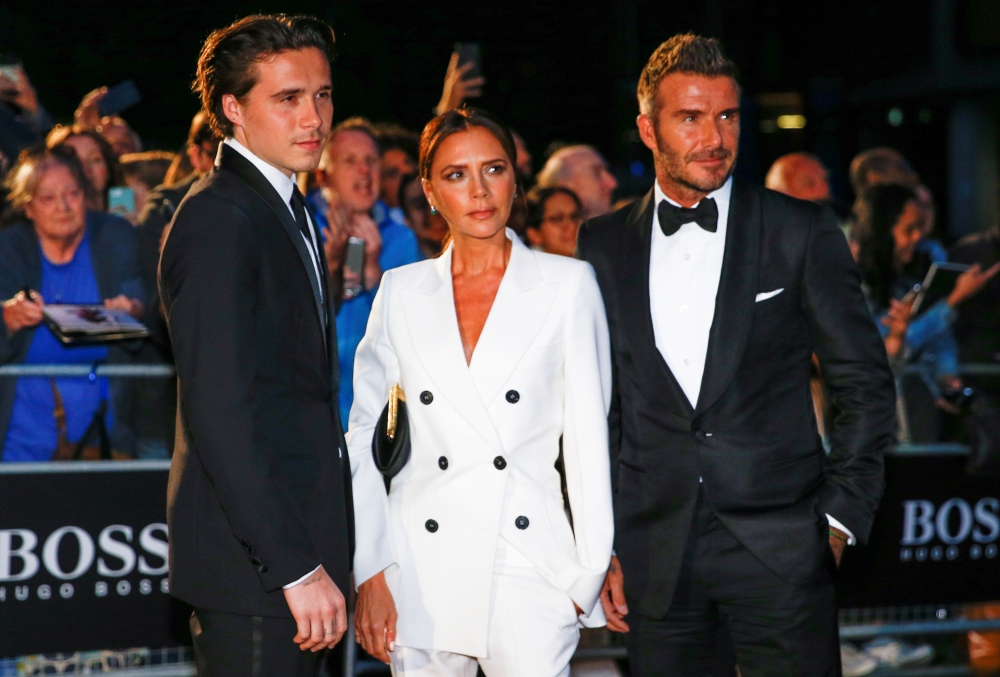 David Beckham, his wife Victoria Beckham and one of their sons, Brooklyn Beckham arrive to the GQ Men Of The Year Awards 2019 in London on Tuesday. — Reuters