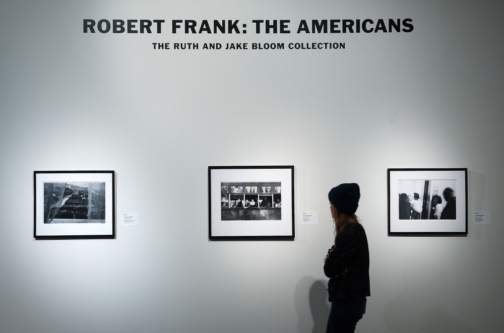 A person looks at rare Robert Frank photographs from his book  Robert Frank, a pioneering documentary photographer whose raw style placed him among the 20th century's greats, has died, according to The New York Times on Tuesday. — AFP