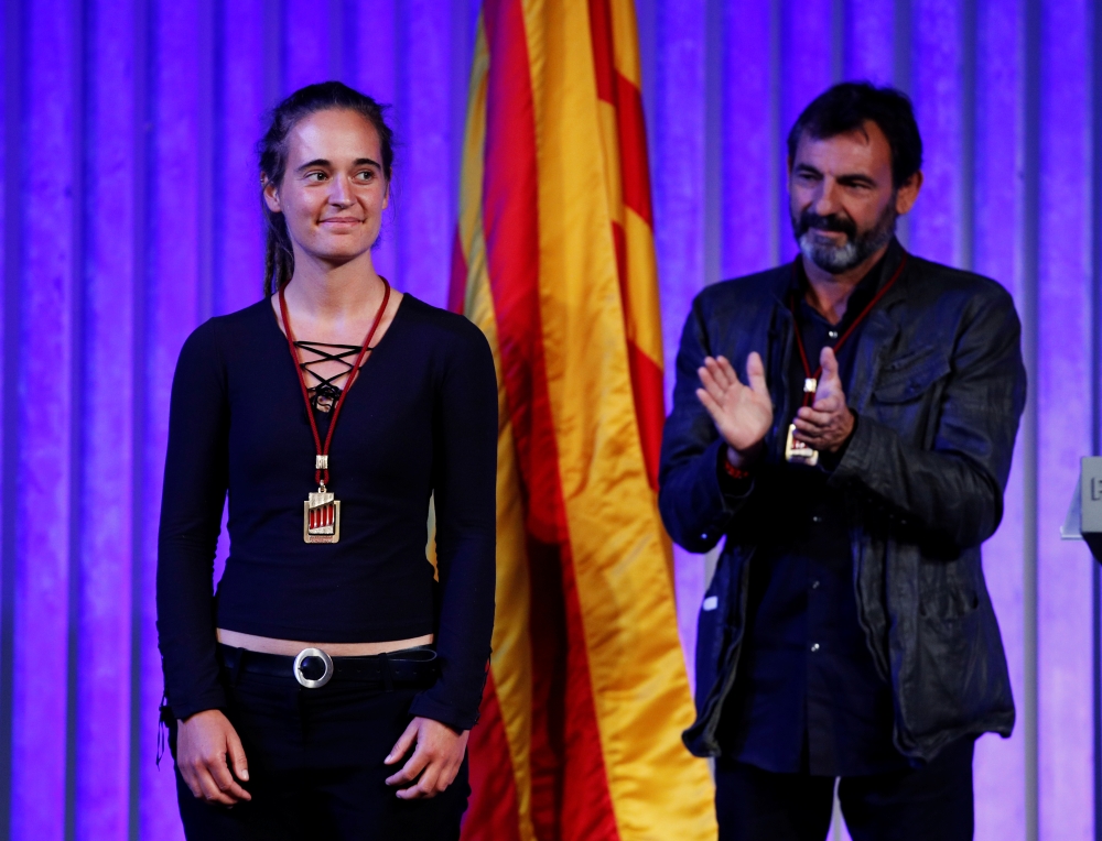 German captain of rescue ship Sea-Watch 3 Carola Rackete is applauded by director of Spanish NGO Proactiva Open Arms Oscar Camps, after they received the Catalan parliament award in Barcelona, Spain on Tuesday. -Courtesy photo 
