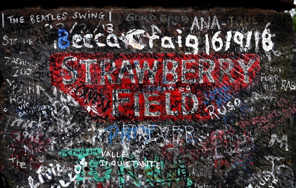 Graffiti is pictured on the gates to Strawberry Field in Liverpool, northwest England on Wednesday. Beatles fans can now take a trip through the childhood sanctuary of John Lennon that inspired seminal song 