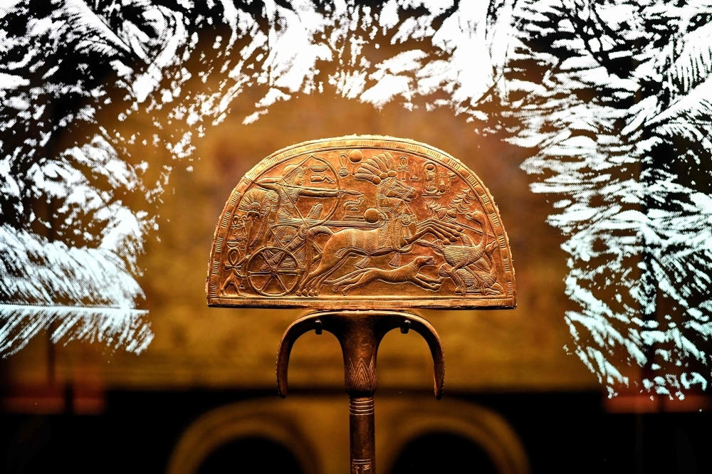 In this file photo taken on March 21, 2019, The sculpture of a gilded wooden fan entitled 'Ostrich Hunt' is displayed during the exhibition 'Tutankhamun,Treasures of the Golden Pharaoh' at La Villette in Paris. — AFP