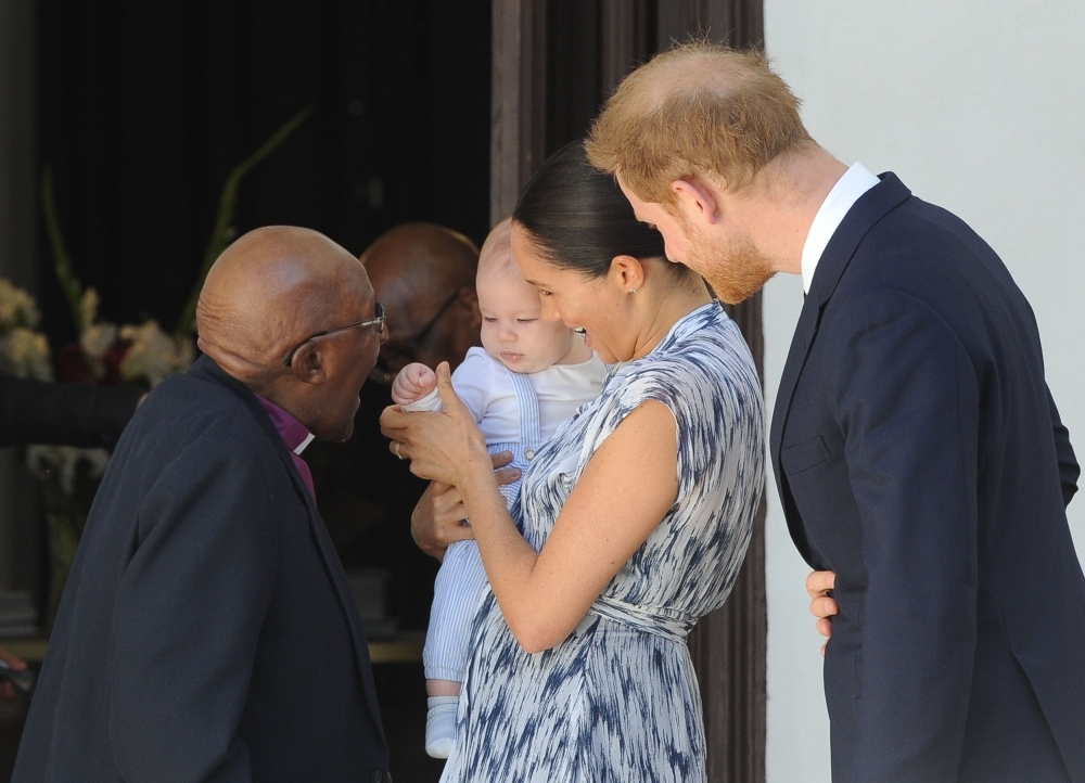The Duke and Duchess of Sussex, Prince Harry and his wife Megha hold their baby son Archie as they meet with Archbishop Desmond Tutu and his wife Leah at the Tutu foundation in Cape Town on Wednesday. — AFP