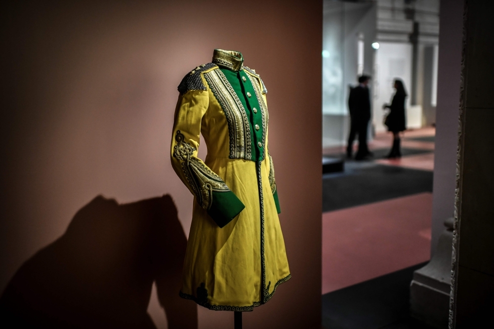 Visitors walk past an painting (1933-1934) showing Indian Maharani Sanyogita Devi of Indore in tradition dress displayed at the opening of 