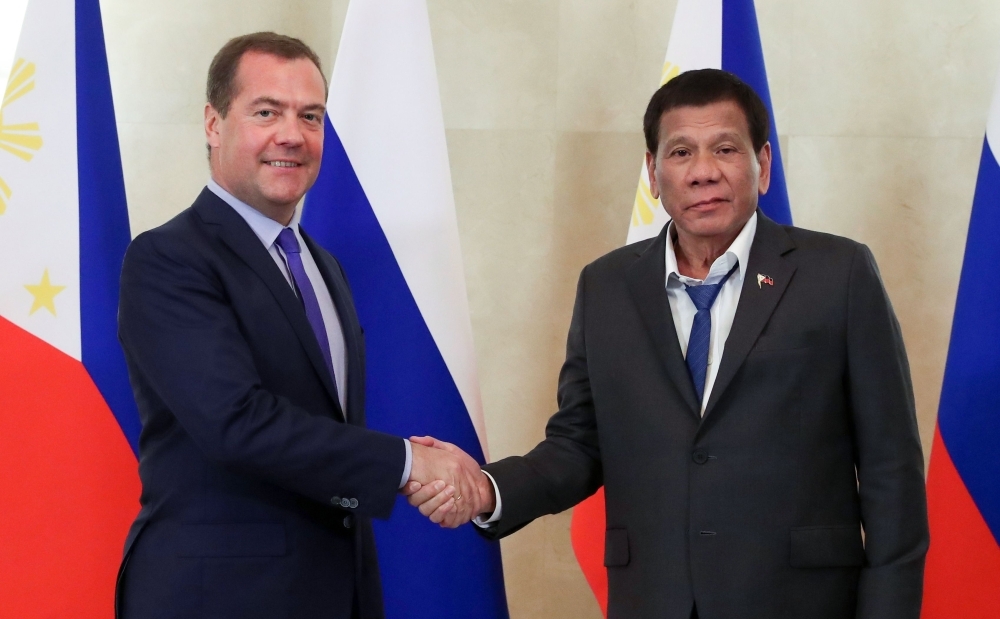 Russian Prime Minister Dmitry Medvedev, left, shakes hands with Philippine President Rodrigo Duterte prior to their meeting in Moscow on Wednesday. — AFP