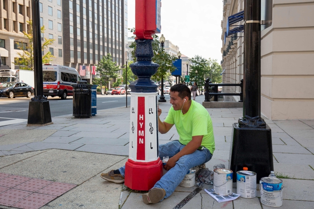 This combination of pictures created on Sept.r 16, 2019 in Washington, DC, shows old call boxes filled with art as part of the Sheridan-Kalorama Call Box Restoration Project by artists. — AFP