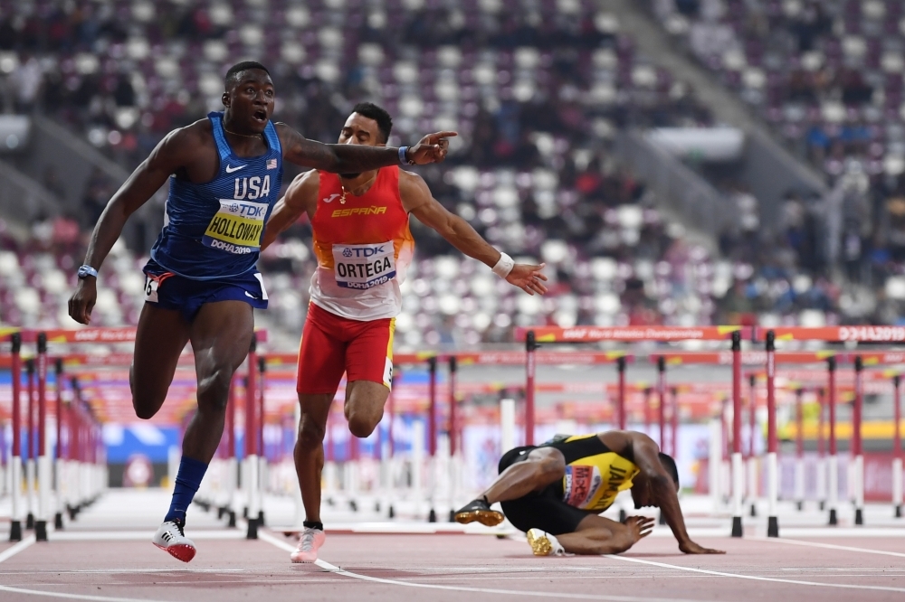 Gold medalist USA's Grant Holloway poses on the podium during the medal ceremony for the Men's 110 Hurdles at the 2019 IAAF World Athletics Championships in Doha on Thursday. — AFP