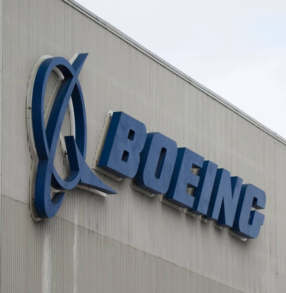 (FILES) In this file photo taken on March 12, 2019 the Boeing logo is pictured at the Boeing Renton Factory in Renton, Washington.  Boeing reported on October 23, 2019 a sharp drop in third-quarter earnings due to the 737 MAX grounding, but said it still expects regulatory approval this year to return the plane to service. The aviation giant, which has been in crisis mode following two MAX crashes that killed 346 people, said it 