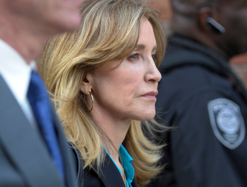 Actress Felicity Huffman exits the courthouse after facing charges for allegedly conspiring to commit mail fraud and other charges in the college admissions scandal at the John Joseph Moakley United States Courthouse in Boston in this April 3, 2019 file photo. — AFP
