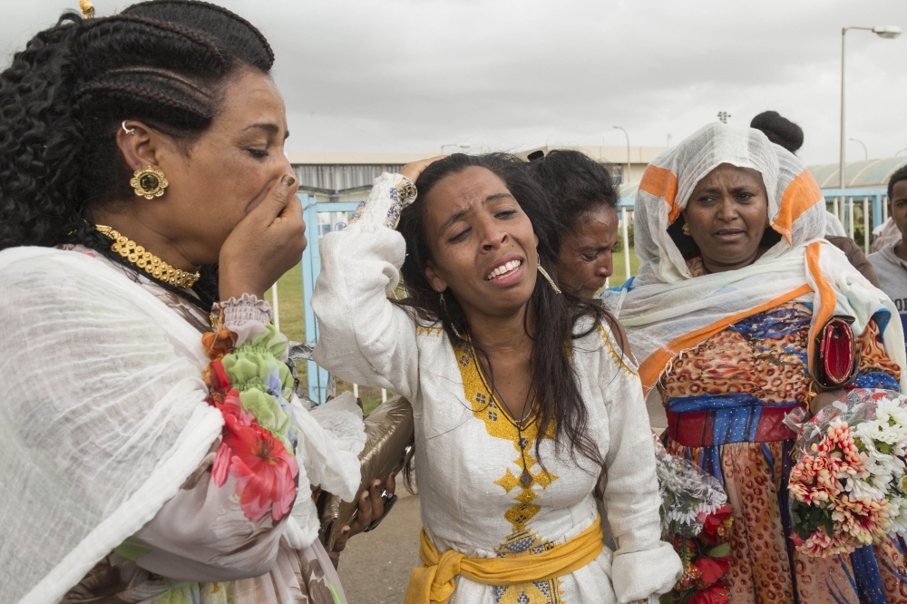Azmera Addisalem, second left, and her family get emotional after meeting her father (who is an Ethiopian journalist) for the first time in twenty years, upon his arrival at the Asmara International airport in this July 18, 2018 file photo. — AFP