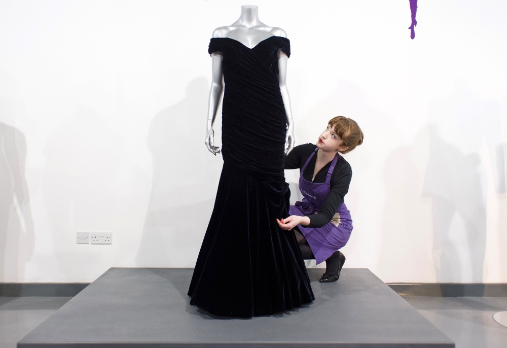 A Victor Edelstein midnight blue velvet evening gown, worn by Britain's Princess Diana at the State Dinner at the White House in 1985, when she danced with US actor John Travolta, is pictured at the Kerry Taylor Auction house in south London ahead of its sale. — AFP