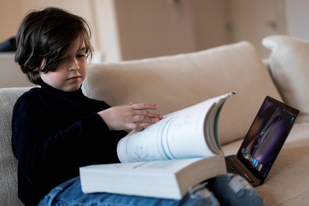 Belgian student Laurent Simons, 9 years old, poses during a photo session at his home in Amsterdam on Thursday. — AFP