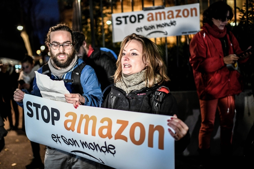 Employees working at the distribution center of US online retail giant Amazon in Dortmund, Germany, in this Nov. 8, 2018 file photo. — AFP