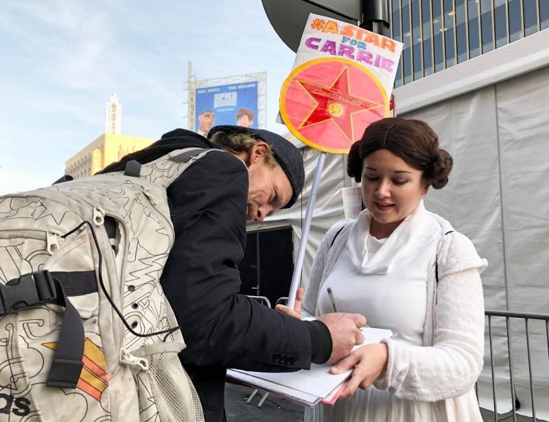 Star Wars fan Kristin Grady, wearing a Princess Leia costume, started a petition for Carrie Fisher, who played Princess Leia, to receive her posthumous Hollywood Walk of Fame Star outside the world premiere of Disney's 