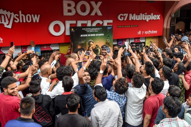 Bollywood actor and stunt performer Vidyut Jamwal, center with black cap, is mobbed by media and fans outside a cinema in Mumbai in this Dec. 1, 2019 file photo. — AFP