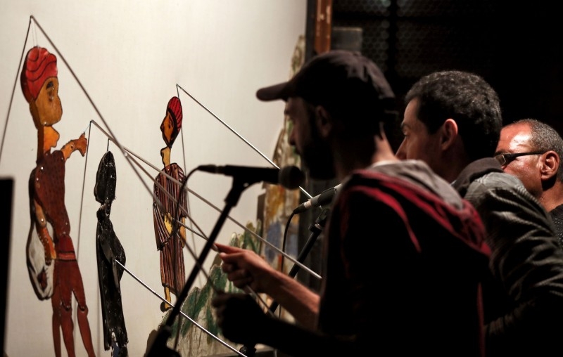 Members of Egypt's Wamda troupe manipulate puppets during a Aragoz puppets show in Beit Al-Sehemi, in Cairo's Gamaliya district, on Nov. 15, 2019. At a historic Islamic Cairo complex, a swarm of spectators scurried for seats to watch Egypt's Aragoz puppet show played by Wamda troupe, the only group striving to save the traditional folk theater.  — AFP