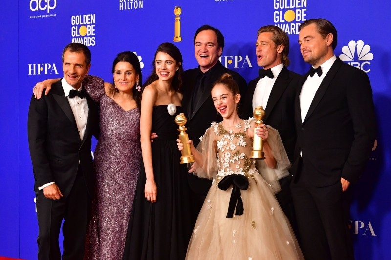 US film director Quentin Tarantino, center, actors US actor Brad Pitt and Leonardo DiCaprio pose with other members of the cast and crew in the press room after winning the award for Best Motion Picture — Musical or Comedy for 