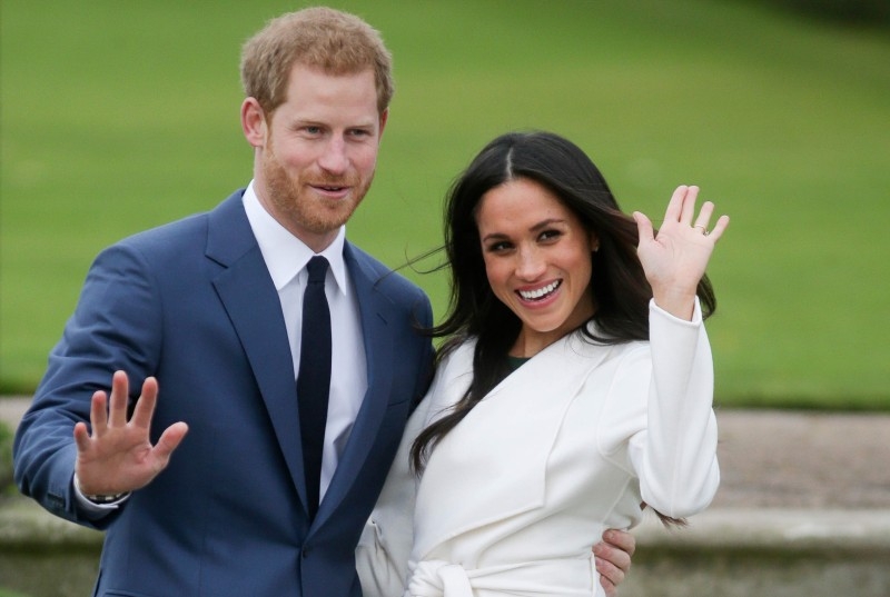 In this file photo taken on Nov.27, 2017 Britain's Prince Harry and his fiancée US actress Meghan Markle pose for a photograph in the Sunken Garden at Kensington Palace in west London. AFP