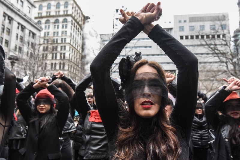 Women inspired by the Chilean feminist group called Las Tesis perform 