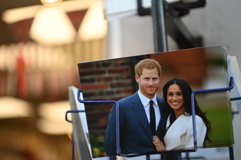 Royal memorabilia featuring Britain's Prince Harry, Duke of Sussex, and Meghan, Duchess of Sussex is displayed for sale in a store near Buckingham Palace in London on Saturday. Prince Harry's wife Meghan has returned to Canada following the couple's bombshell announcement that they were quitting their frontline royal duties. — AFP