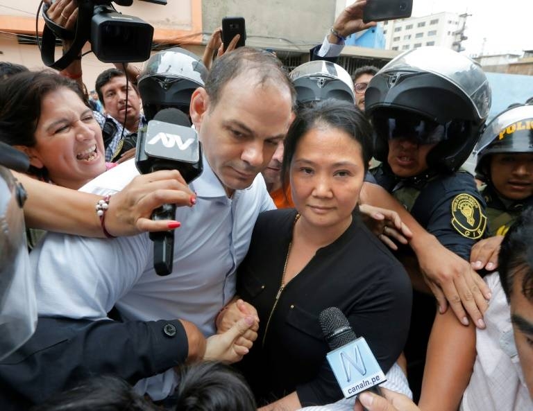 Keiko Fujimori arrives at a Lima courthouse with her husband Mark Villanella on Tuesday. — AFP