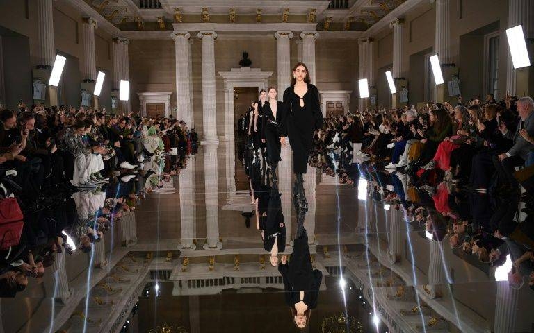 Models present a creation at the Victoria Beckham catwalk show during London Fashion Week in London on Sunday. — AFP