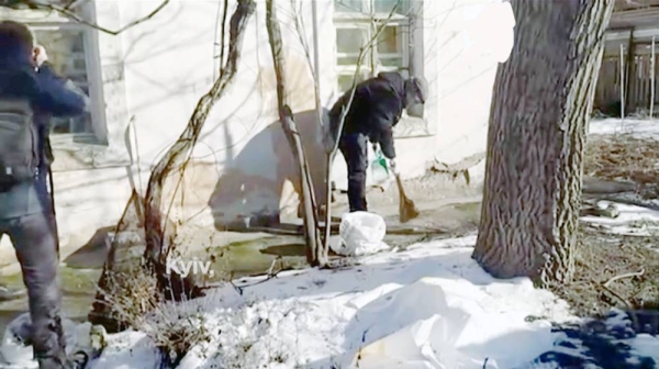 Ukrainians clear up the debris after Russian strikes in the Donetsk region.