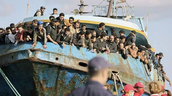 Migrants look out of a fishing boat docked at the port of Palaiochora in southeastern Crete, Greece, after its arrival, on Nov. 22, 2022. — courtesy InTime News via AP