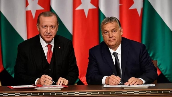 Turkish President Recep Tayyip Erdogan, left, and Hungarian Prime Minister Viktor Orban sign a document during their meeting in Budapest, Hungary, on Nov. 7, 2019