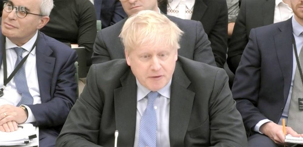 
Former British PM Boris Johnson takes an oath on the Bible before being grilled in the Partygate saga in London on Wednesday.