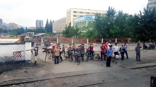 A rare photo taken inside North Korea during the pandemic, showing people at a crossing in Phyongysong. — courtesy NK News