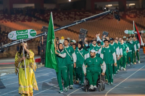 Saudi athletes participate in the parade.