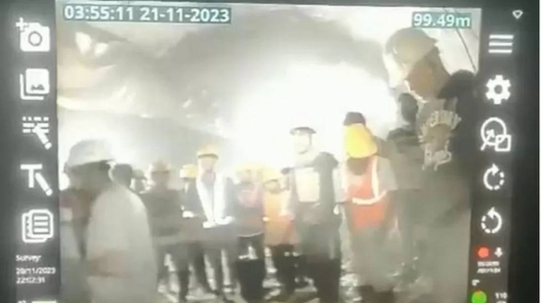 The workers seen on a monitor in the control room