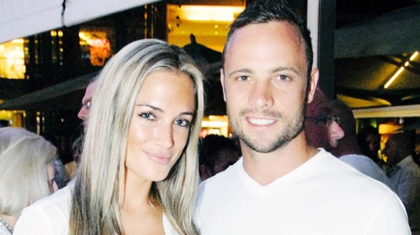 A file picture shows Olympian sprinter Oscar Pistorius posing next to his girlfriend Reeva Steenkamp at Melrose Arch in Johannesburg. — courtesy Getty Images