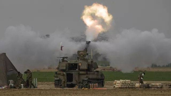 An Israeli mobile artillery unit fires a shell from southern Israel towards the Gaza Strip, in a position near the Israel-Gaza border on Sunday, Dec. 10, 2023