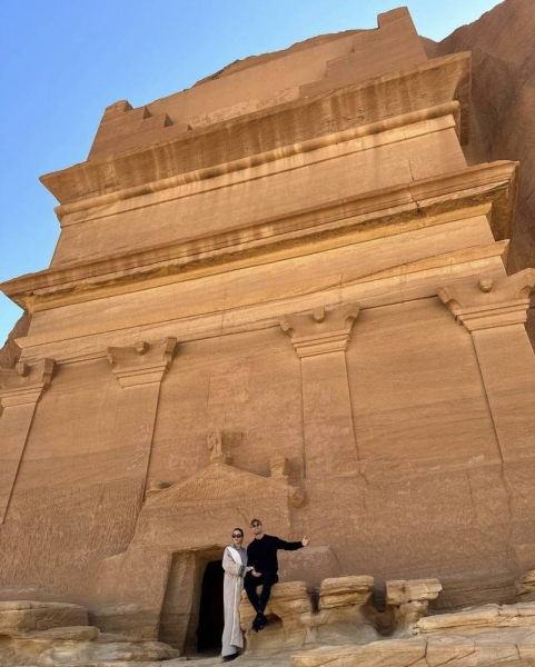 Cristiano Ronaldo and Georgina Rodriguez posing in front of Jabal AlBanat in Hegra. This site is among the over 100 monumental tombs carved into the rocky outcrops surrounding the ancient city. Jabal AlBanat itself features a significant cluster of these tombs, with 29 carved into the sandstone rock on all its sides.