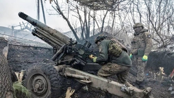 Ukrainian soldiers reload an artillery unit on the front line. — courtesy Getty Images