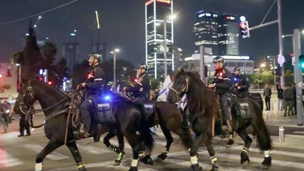 Riot police on horseback clash with anti-government demonstrators in Tel Aviv. — courtesy Getty Images