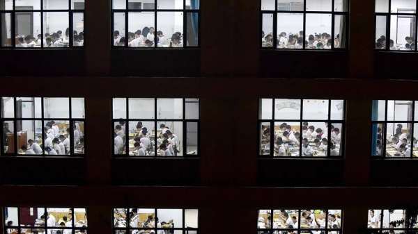 High school students going through exam papers, ahead of the National College Entrance Examination (NCEE), known as 'gaokao', in Handan, in China's northern Hebei province