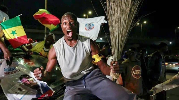 A Supporter of Senegalese presidential candidate Bassirou Diomaye Faye celebrates early results showing that Faye is leading initial presidential election tallies, in Dakar, Senegal. — courtesy Reuters