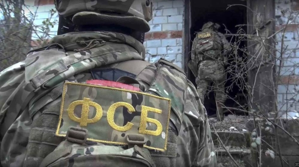 Officers from the Federal Security Service's special forces check a house in Nalchik, Russia
