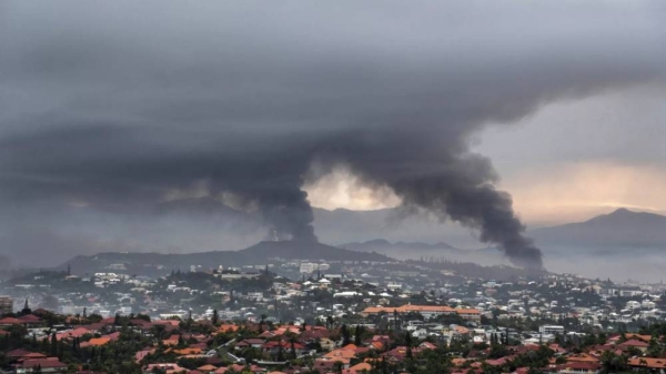 Smoke rises during protests in Noumea, New Caledonia, Wednesday May 15, 2024