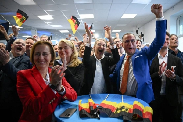 Alternative for Germany (AfD) party co-leaders Alice Weidel and Tino Chrupalla cheer the exit poll in Berlin, Germany, June 9, 2024